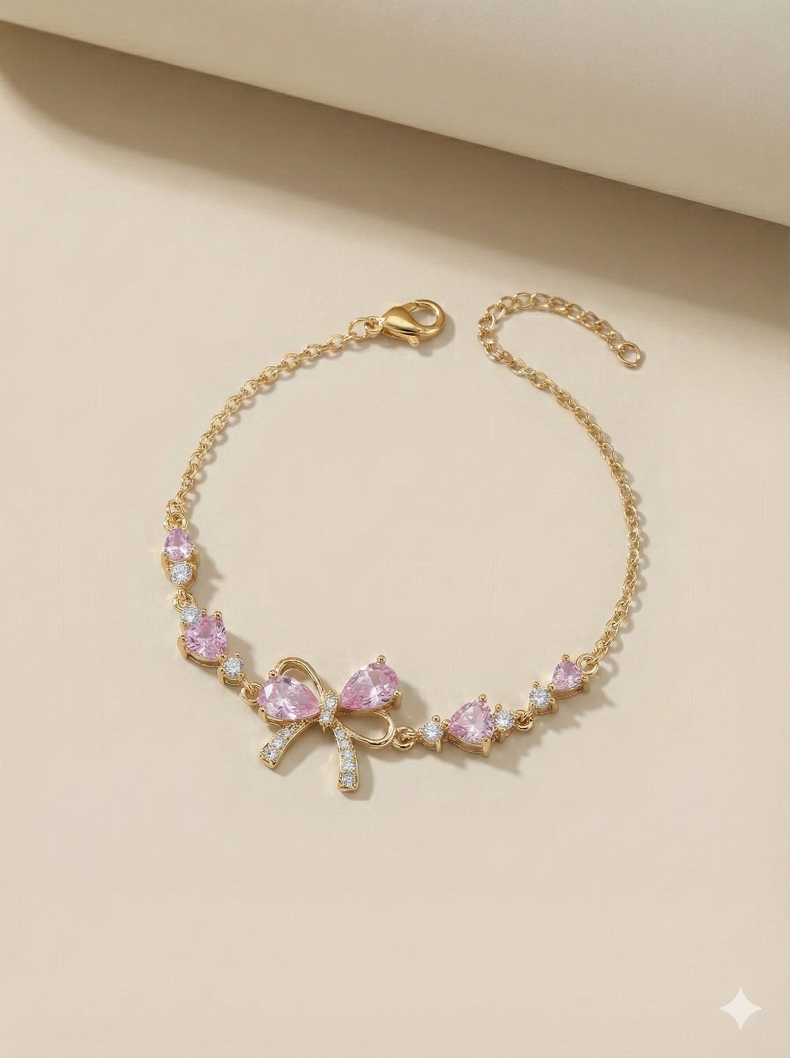 Gold-Tone Adjustable Chain Bracelet with Pink Teardrop Stones and Pave-Style Bow Charm