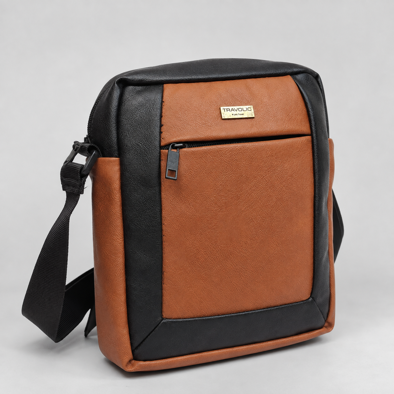 Tan and black two-tone faux leather crossbody sling bag front view
